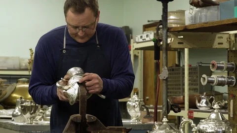 Silversmith working on a teapot in a workshop 動画素材 83399874