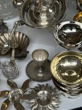 Silverware assortment displayed with various bowls, cups, and utensils as a.. Stock Photos