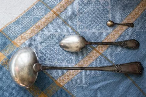 Silverware on a blue tablecloth. Stock Photos