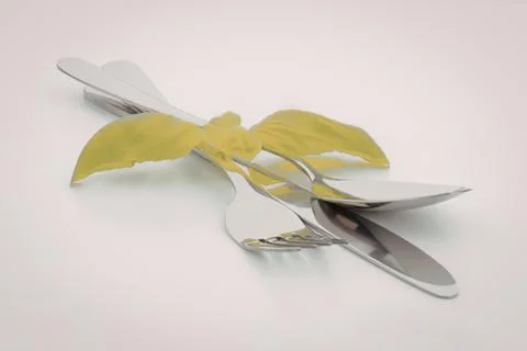 Silverware with fresh green basil leaves Stock-Fotos