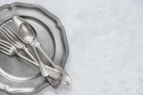 Silverware on a pewter plate Stock Photos