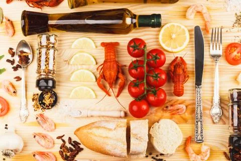 Silverware with spices, cherry tomatoes and cancers Stock Photos