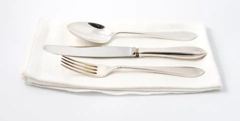 Silverware on white napkin Stock Photos