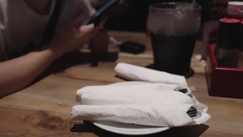 Silverware wrapped in clean white napkins on a white plate at a restaurant .. Stock Footage 342385323