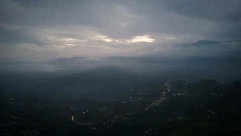Silvery Apertures in Brooding Overcast Above Twinkling Settlement Stock Footage 316798373