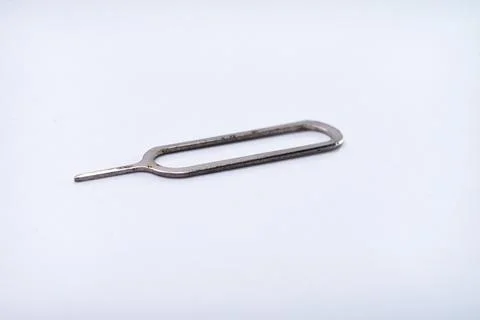 The sim card ejector is made of iron in the photo on a white base and with .. Foto stock