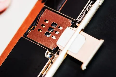 The SIM card is inserted into the smartphone, close-up, Stock Photos