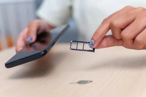 Sim card insertion action home setting technology focus close-up view mobil.. Stock Photos