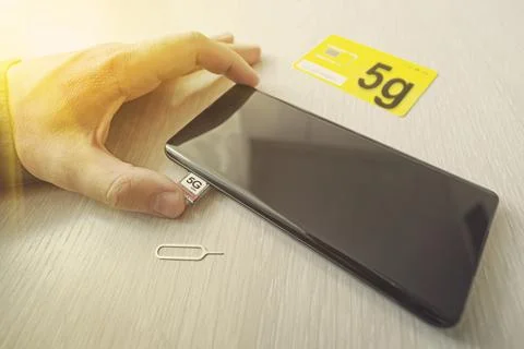 SIM card labeled 5g. Replacing a SIM card in mobile phone with high-speed I.. 写真素材