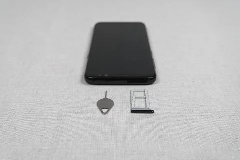 Sim card tray, eject tool, smartphone Stock Photos