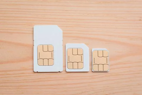 SIM cards of different side on a wooden background Stock Photos