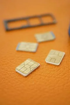 SIM cards placed on a textured surface during device setup Stock Photos