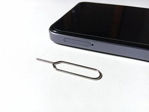 SIM tray hole on smartphone. Stockfoto's