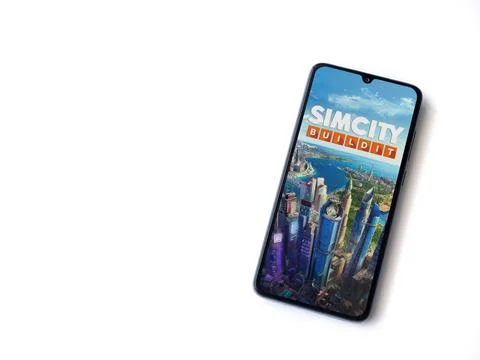 SimCity BuildIt app launch screen on smartphone on white background Stock Photos