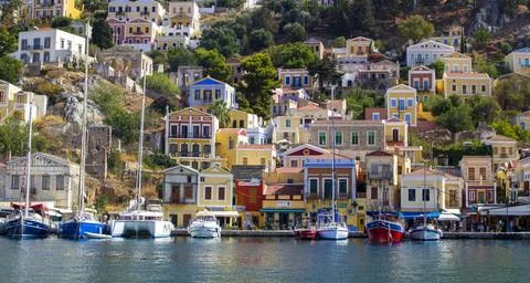 Simi, GREECE - MAY 2019: Islands Symi.Colorful houses and boats and yachts . Stock Photos