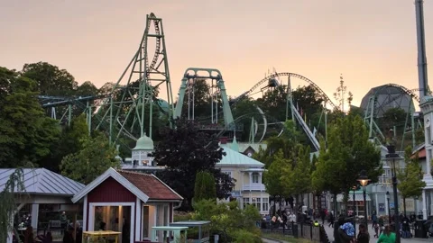 Similar Elevated Park View with Roller Coasters and Visitors Moving Through the 库存影片 347681420