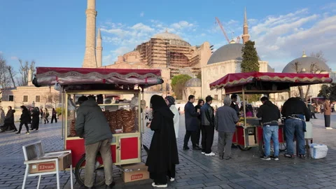 A simit vendor sells simit in front of Hagia Sophia mosque in Istanbul, Turkey Stock Footage 328340742