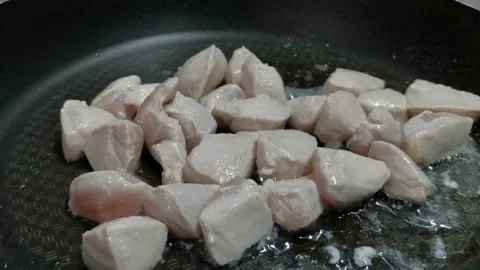 Simmering Chicken Breast Cubes with Small Amount of Water Stock Footage 234882503