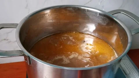 Simmering Pork Ribs with Mashed Tomatoes Stock Footage 159292208