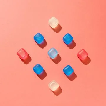 Simmetrical square composition from colored plastic cubes on a background i.. Stock Photos