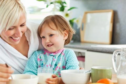 Simper mother having breakfast with her daughter Stock Photos