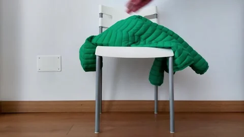Simple Action: Hand Puts Jacket on Chair Stock Footage 323432531