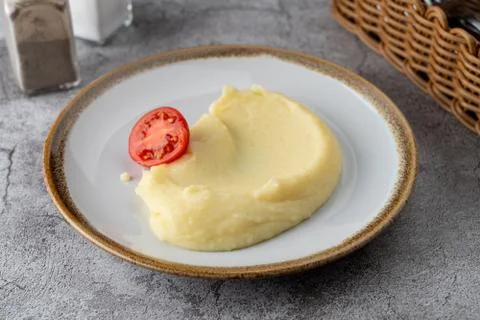 Simple all-purpose garnish: mashed potato puree with a slice of ripe tomato Stock Photos