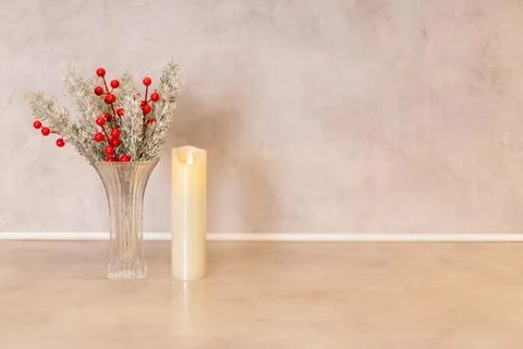 Simple and elegant table decor with red berries, greenery, and a candle in a Stock Photos