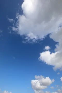 Simple background of blue sky and white clouds in vertical development with.. Stock Photos