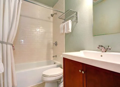 Simple bathroom interior with tile wall trim Stock Photos
