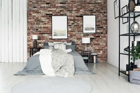 Simple bedroom with brick wall Stock Photos