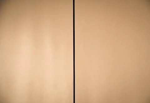Simple beige background with a vertical dark line Stock Photos