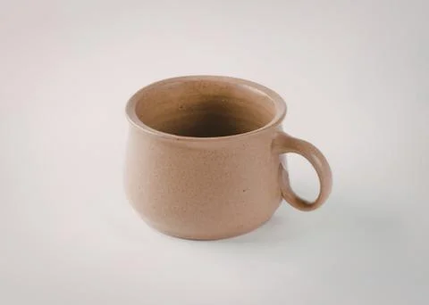 Simple beige ceramic mug with handle Photos