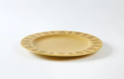 Simple beige ceramic plate with decorative border Foto stock