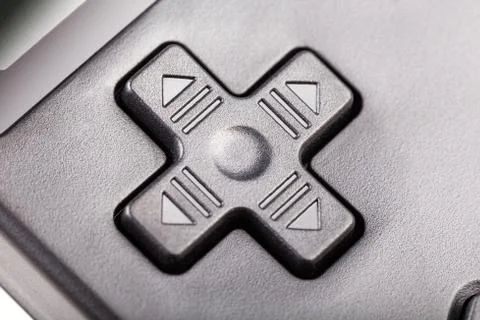 Simple black four directional d-pad. Traditional game controller buttons macro Stock Photos