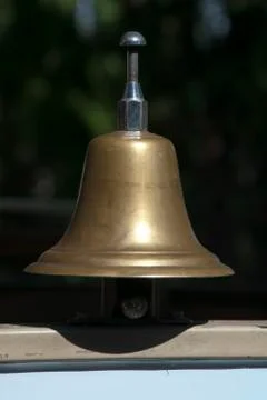 Simple brass bell on windowsill Stock Photos