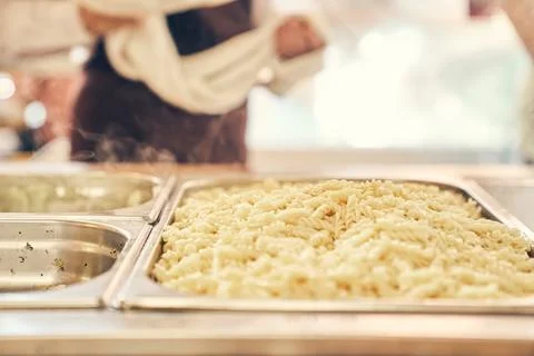 A simple buffet concept. Selective focus on boiled pasta, lying in a metal tray Stock-Fotos