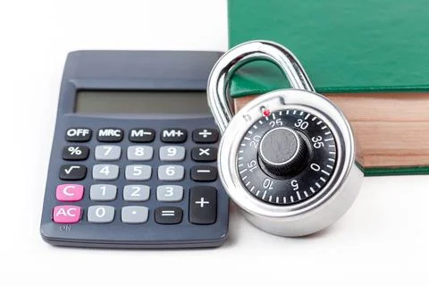 Simple calculator, coded padlock and a closed book, math textbook on the table Stock Photos