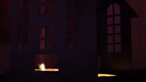A simple candle glows softly inside a dark castle, casting fearsome shadows Stock Footage 319751359