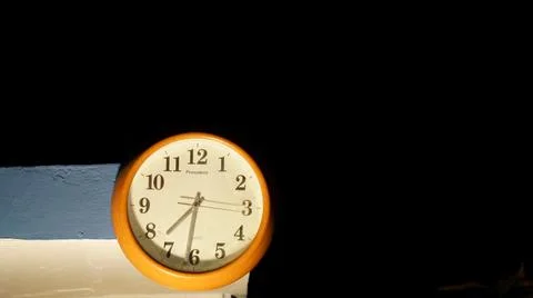 Simple circle watch closeup with 7:30 pm. White circle watch with needle. Tim Stock Photos