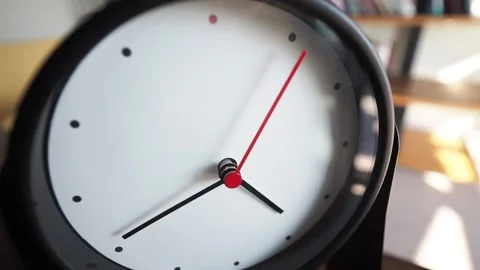 Simple clock shows time passing in cozy workspace Stock Footage 318503074