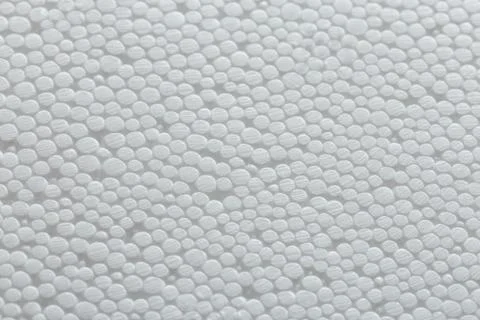 Simple close-up flat but bumpy background of white polystyrene foam or styrofoam Stock Photos