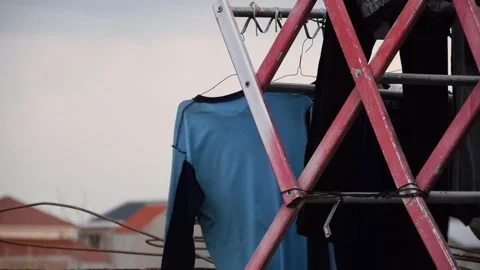 Simple clothes drying on steel rack on rooftop in Indonesia Stock Footage 312057309