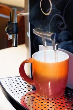 Simple coffee machine preparing a coffee to a mug Stock-Fotos