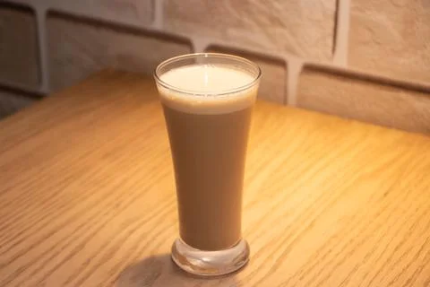 Simple Cold Coffee or Iced Latte in a Tall Glass on Wood Table with Soft Li.. Stock Photos