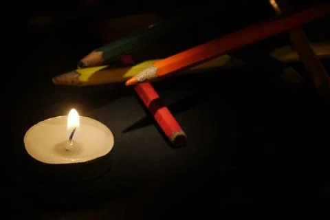 Simple composition of colored pencils and candle, bodegon Stock Photos