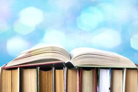 Simple composition of hardback books, raw books on wooden deck table and blue Stock Photos