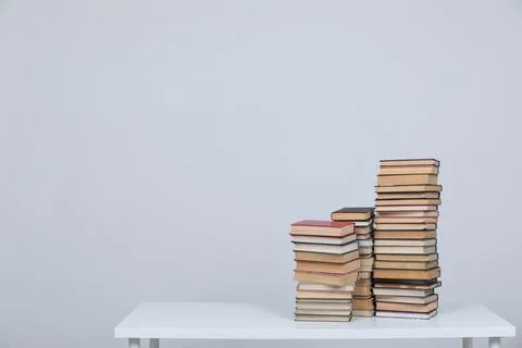 A simple composition of many books, stack or pile of books on wooden table, one Stock Photos