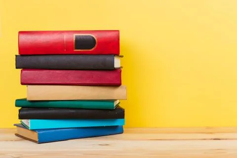 Simple composition of many hardback books, raw of books on wooden table and p Stock Photos