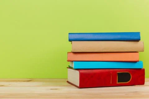 Simple composition of many hardback books, raw of books on wooden table and l Stock Photos